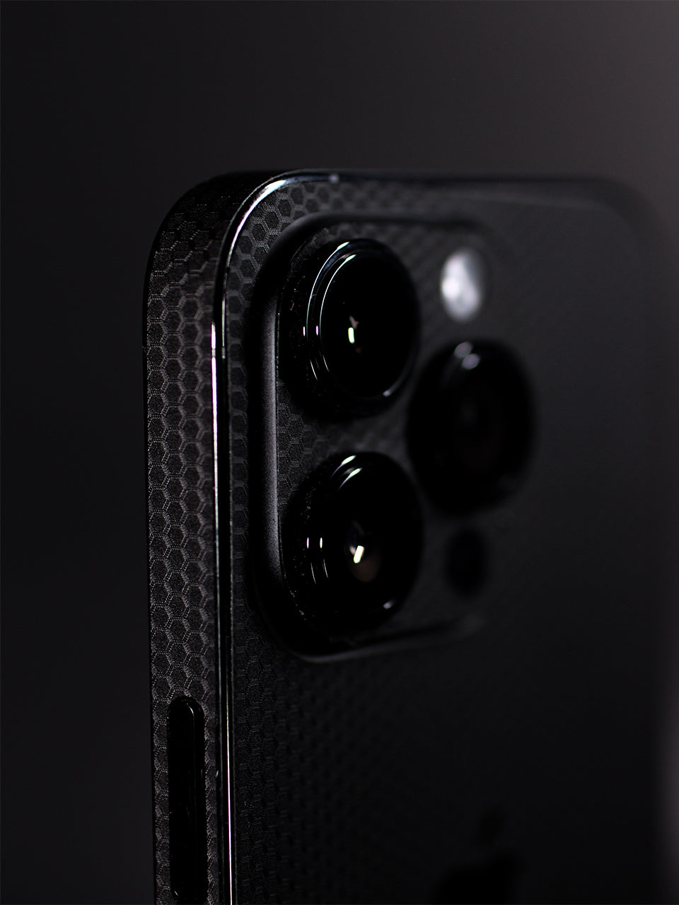 A Black Matrix-patterned iPhone Vinyl Skin photographed in a studio setting with a gray background.