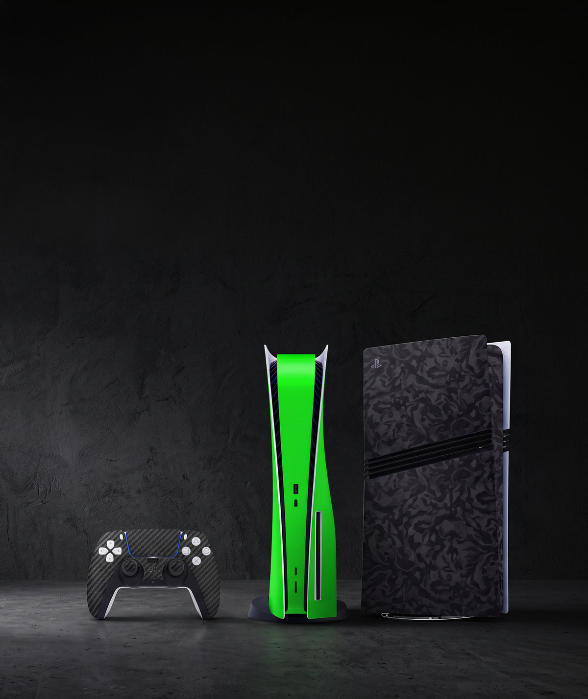 PS5 consoles arranged on a dark wooden table in low light, featuring different vinyl skin designs, including a black skin, a patterned skin, and a light gray skin. The console details and skin patterns are clearly visible.