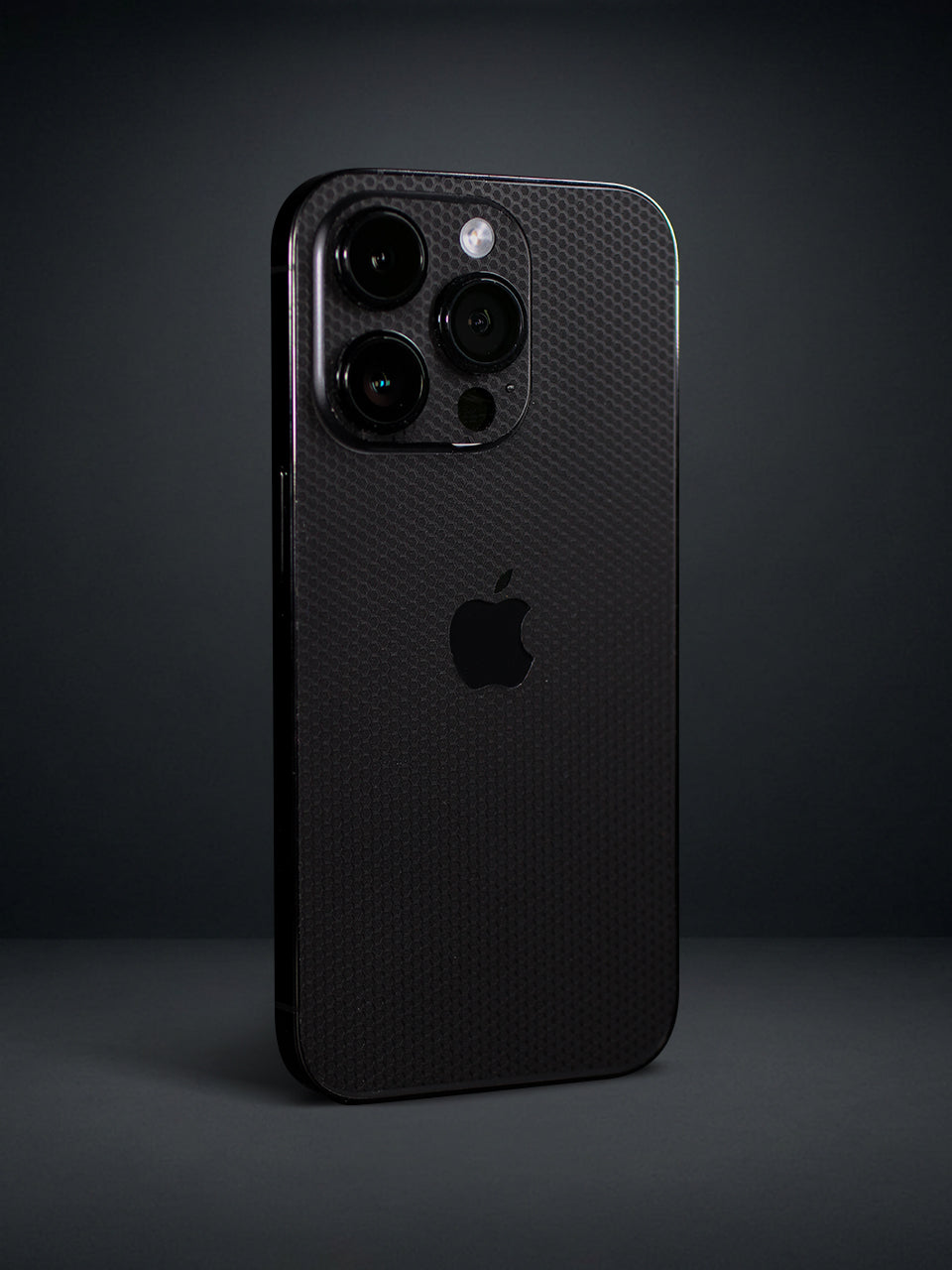 A matrix patterned iPhone Vinyl Skin photographed in a studio setting with a gray background.