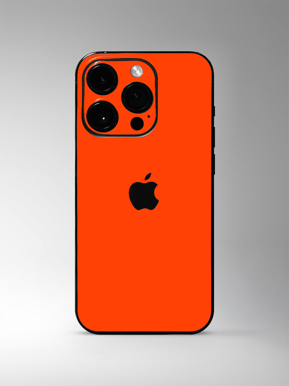 A Neon Red-patterned iPhone Vinyl Skin photographed in a studio setting with a gray background.