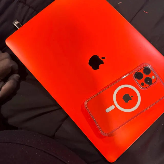 Real Customer Using Neon Orange Vinyl Skin on Apple iPhone Pro and MacBook